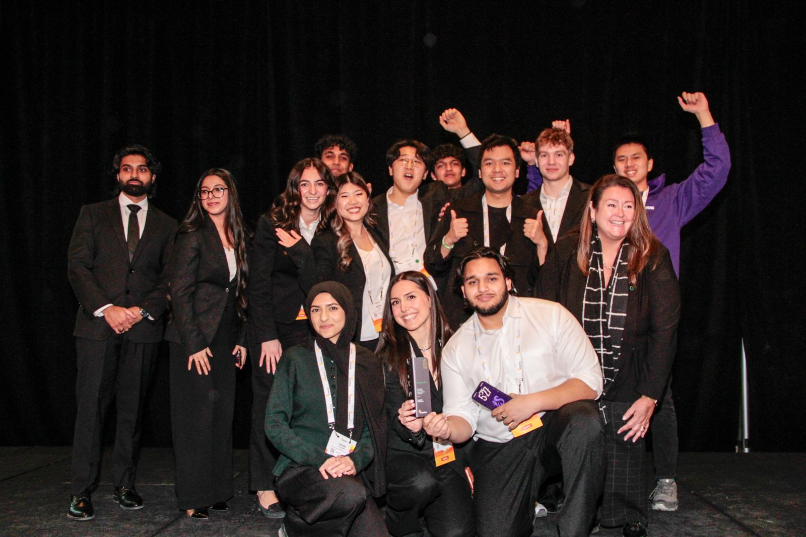 The Squirl Signs team celebrating on stage with an award